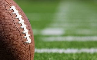 An American Pro Football Ball on a Football Field