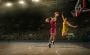 A young woman playing basketball.